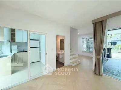 Spacious modern living area with open kitchen and large windows