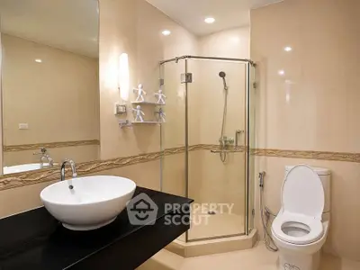 Modern bathroom with glass shower and stylish sink in elegant home.