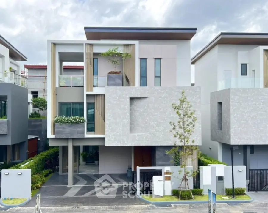 Modern luxury house with sleek design and large windows in a serene neighborhood.
