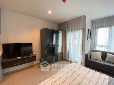 Modern bedroom with sleek wardrobe, TV, and cozy seating area near large windows.