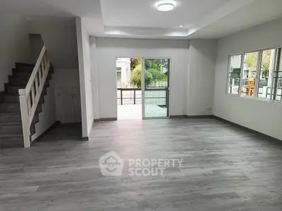 Spacious modern living room with large windows and sleek flooring