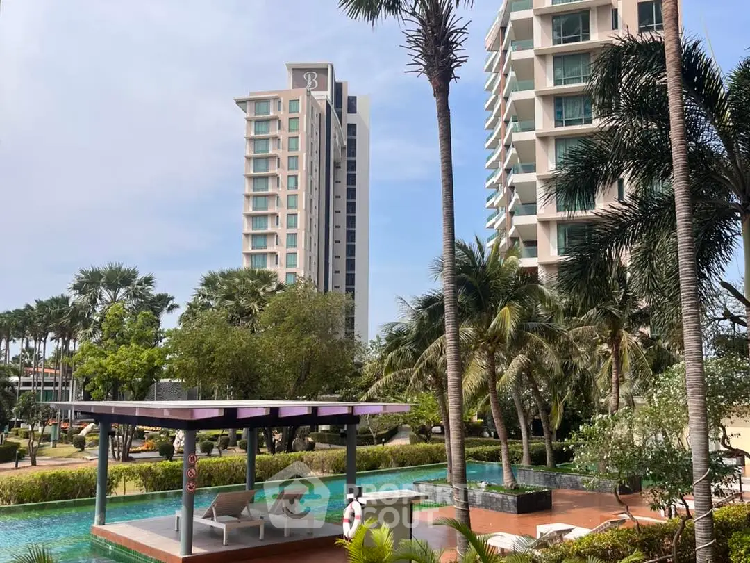 Luxurious residential complex with pool and lush greenery, offering a serene tropical lifestyle.