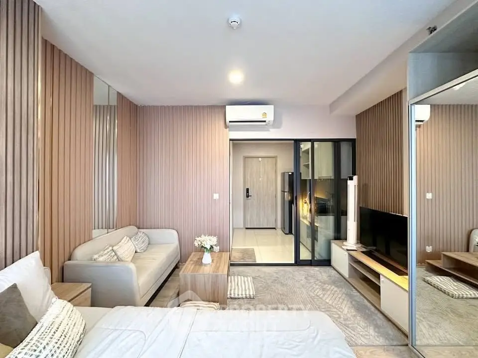Modern living room with stylish decor and open layout, featuring a cozy sofa and sleek TV unit.