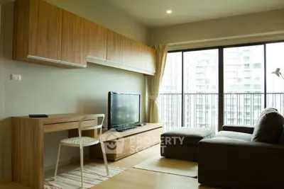 Modern living room with large windows and wooden furniture in a high-rise apartment.