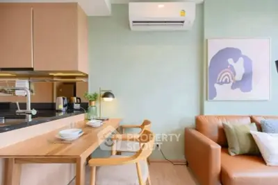 Modern living room with stylish decor and open kitchen layout.