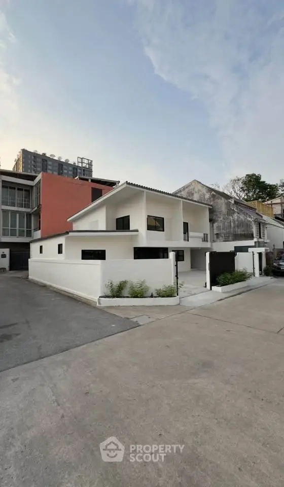 Modern white house exterior with minimalist design and spacious driveway