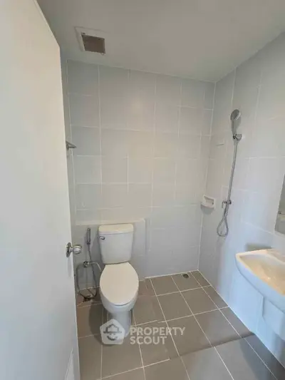 Modern bathroom with sleek fixtures and neutral tile design.