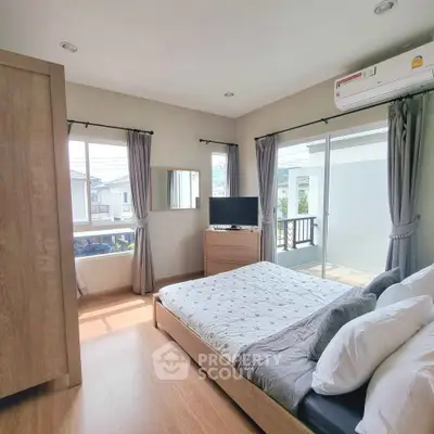 Bright and airy bedroom with modern furnishings and balcony access