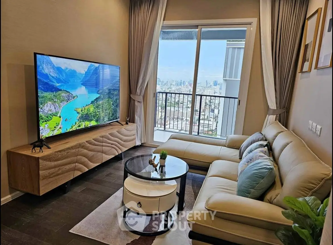Modern living room with large TV and balcony view in stylish apartment