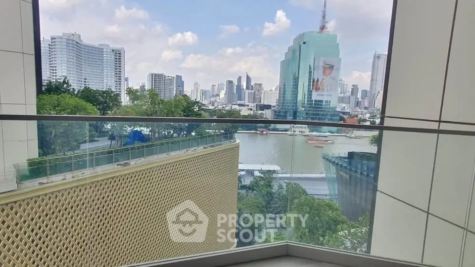 Stunning cityscape view from a modern balcony overlooking a river and skyline.