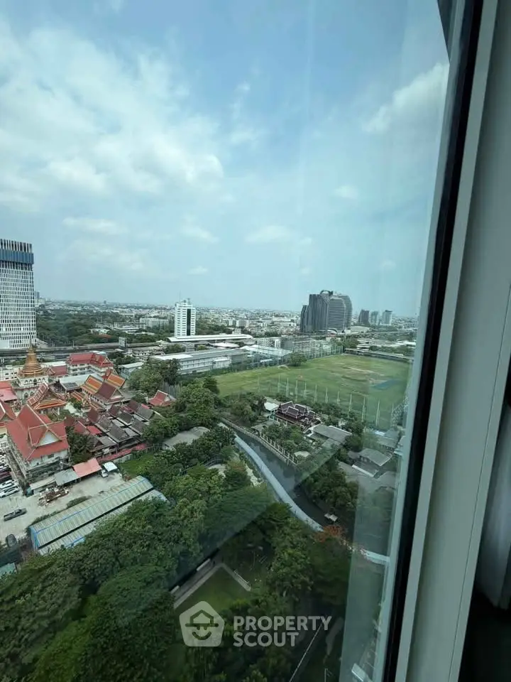 Stunning high-rise view showcasing cityscape and lush greenery, perfect for urban living enthusiasts.