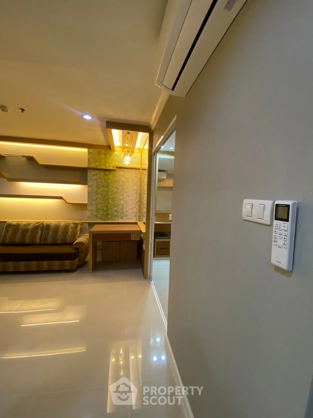 Modern living room with sleek design and ambient lighting, featuring a cozy sofa and stylish wall shelves.