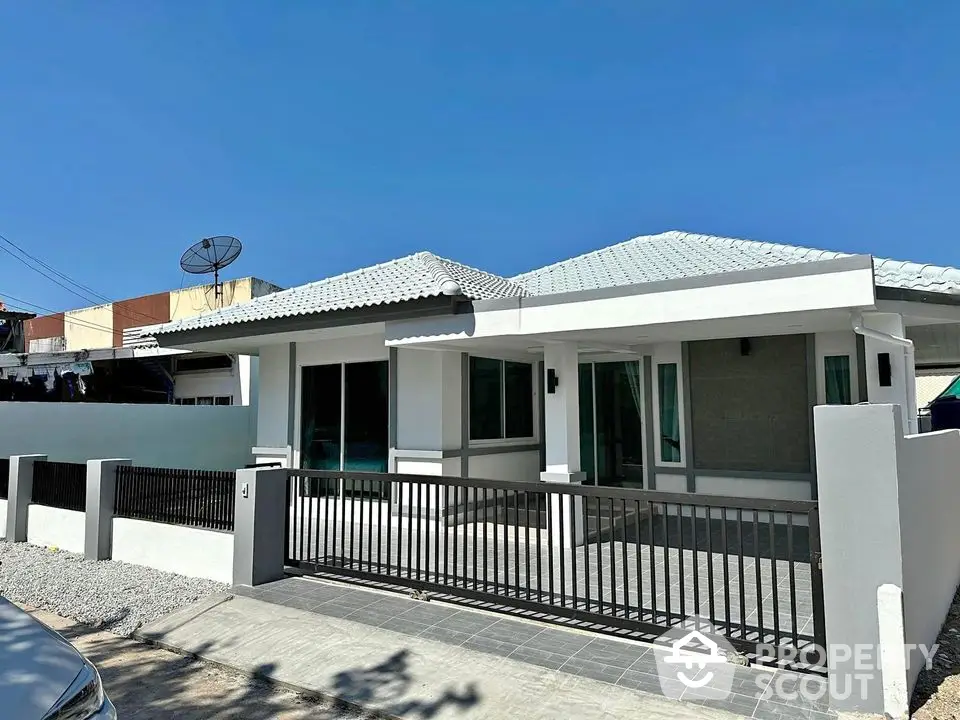 Charming single-story house with modern design and spacious front yard in a serene neighborhood.