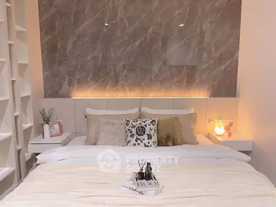 Luxurious bedroom with elegant decor and ambient lighting, featuring plush bedding and stylish accents.