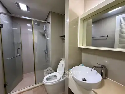 Modern bathroom with glass shower and sleek fixtures