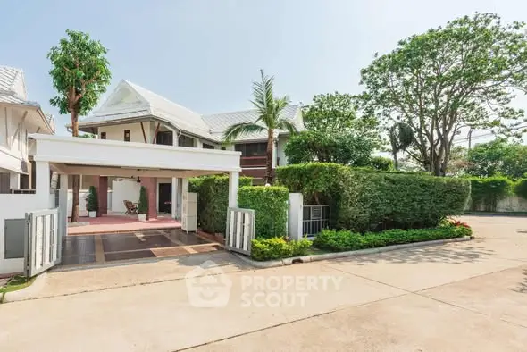 Charming suburban house with lush greenery and spacious driveway