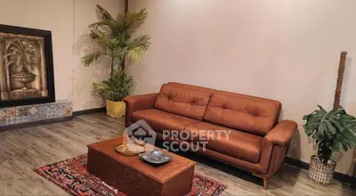 Stylish living room with brown sofa, elegant decor, and vibrant rug