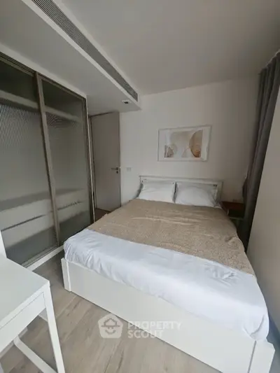 Cozy modern bedroom with stylish decor and ample natural light