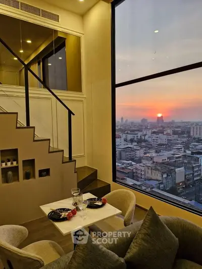 Stunning city view from modern loft apartment with elegant dining setup and large windows.
