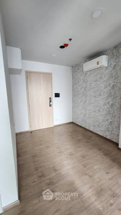 Modern minimalist room with wooden flooring and air conditioning