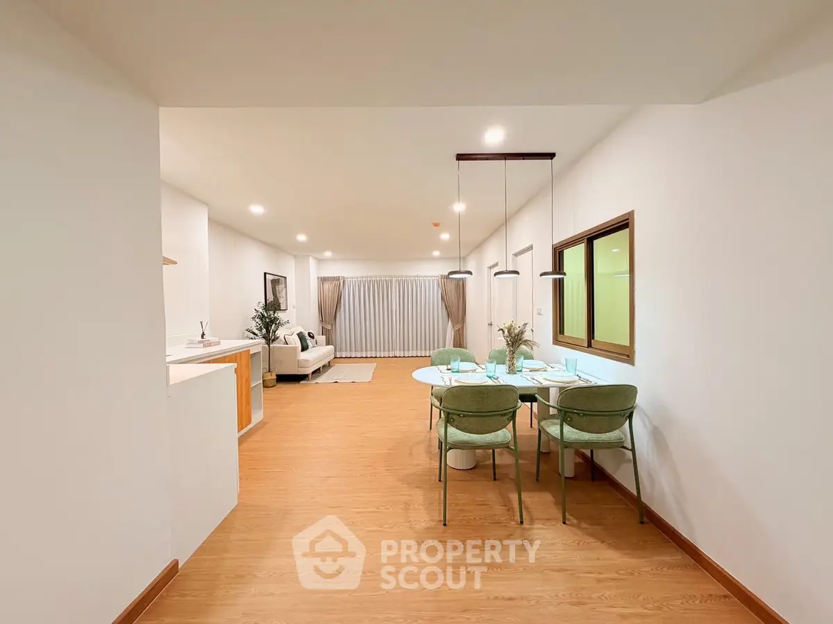 Spacious open-plan living and dining area with modern decor and ample natural light.