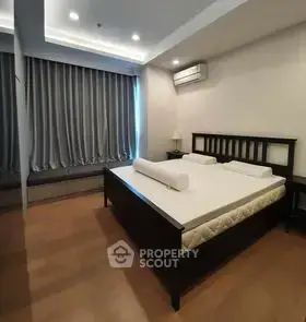 Spacious bedroom with modern design and large window for natural light.