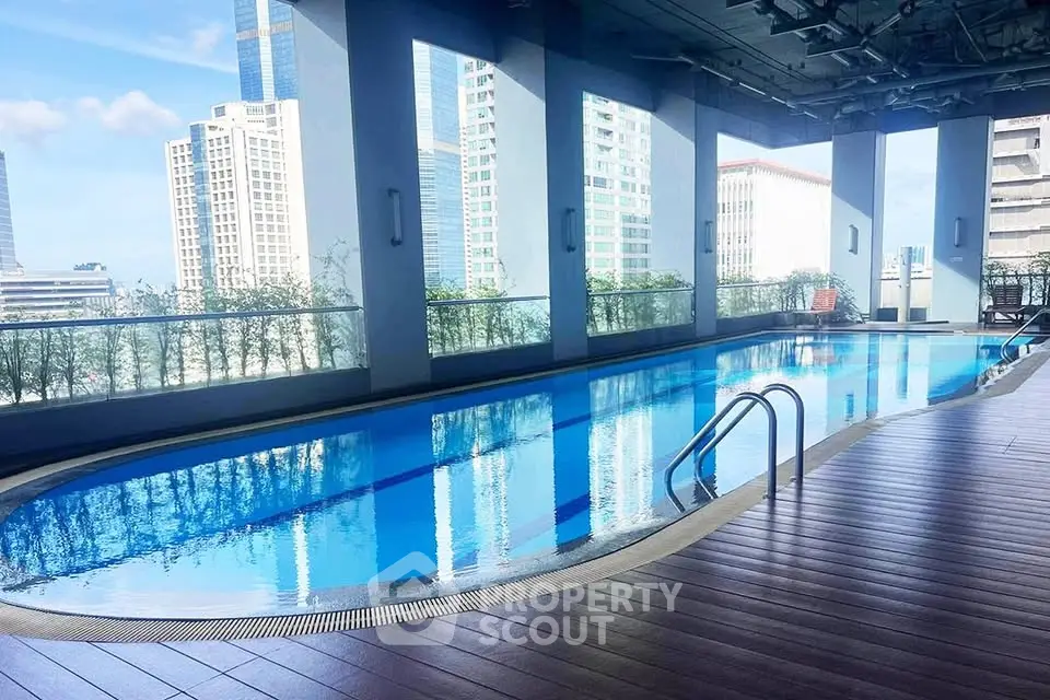 Luxurious rooftop pool with stunning city views in modern high-rise building.