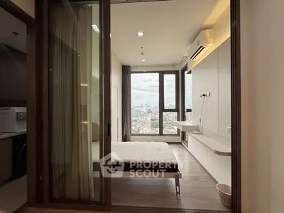 Modern bedroom with large windows and city view, featuring sleek design and air conditioning.