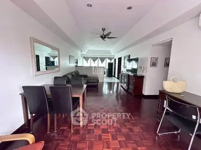 Spacious living room with elegant parquet flooring and modern furniture in a stylish apartment.