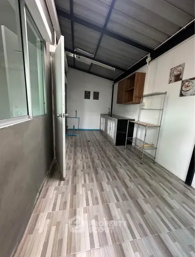 Spacious kitchen with modern open layout and ample storage space.