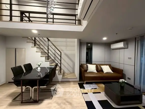Modern duplex living room with stylish furniture and elegant staircase