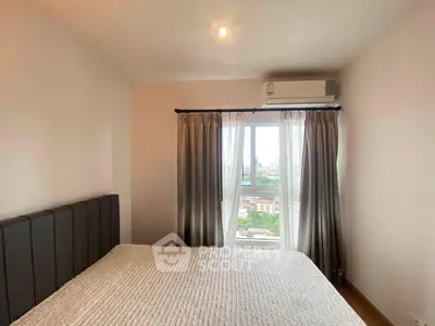 Cozy bedroom with large window offering stunning city views and modern air conditioning unit.