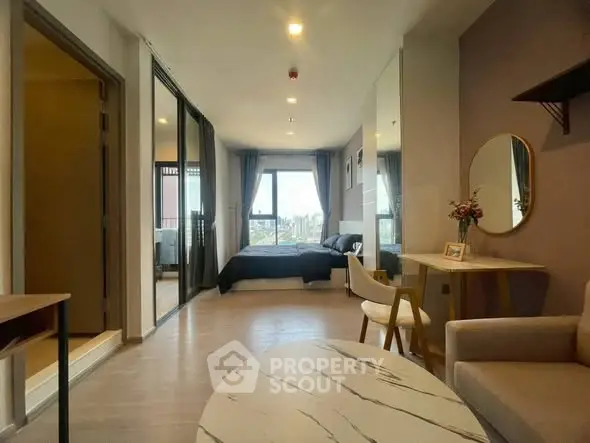 Modern studio apartment with open layout and stylish decor, featuring a cozy living area and bedroom with city view.