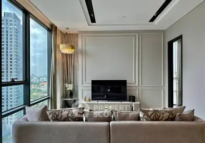 Luxurious living room with modern decor and stunning city view through large windows.