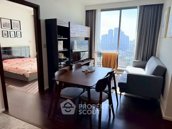 Modern apartment with open living and dining area, featuring a stunning city view from the balcony.