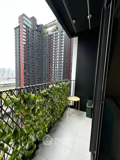 Modern balcony with lush greenery and city view in high-rise apartment