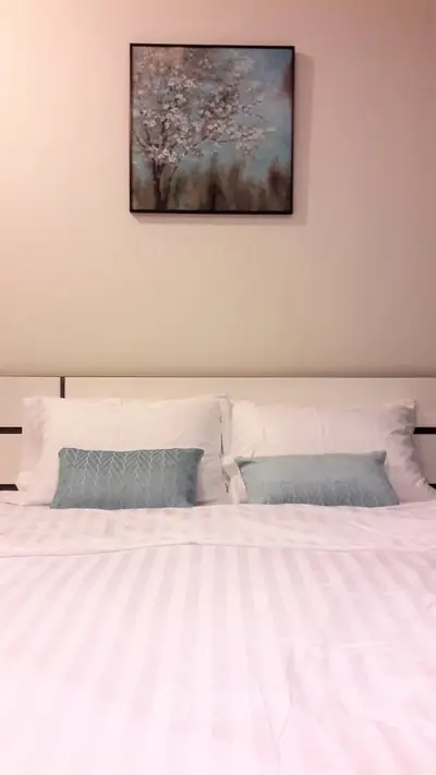 Cozy bedroom with elegant decor and stylish bedding, perfect for relaxation.