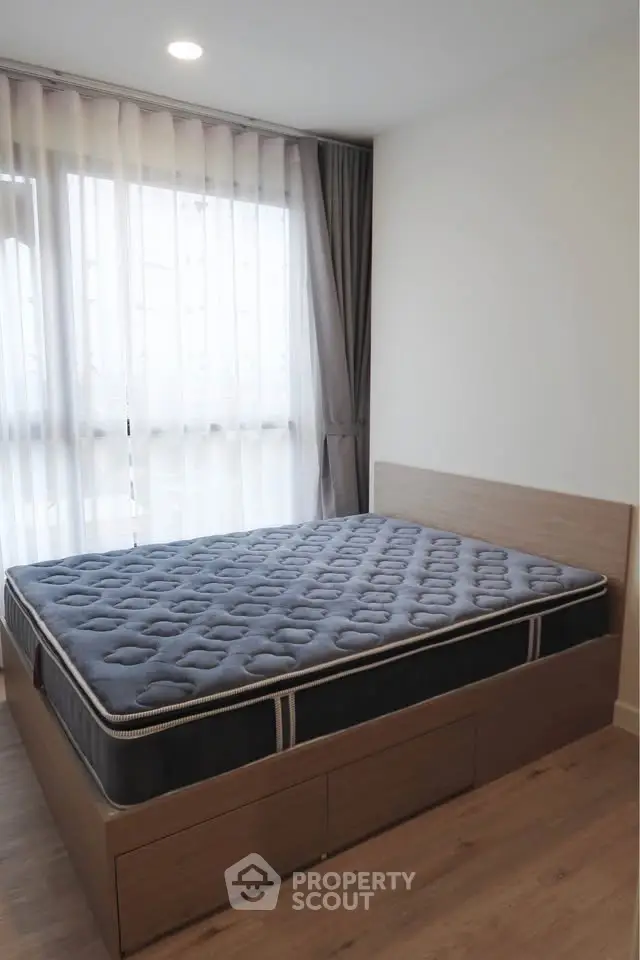 Modern bedroom with large window and stylish bed frame