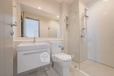 Modern bathroom with sleek fixtures and spacious shower in a contemporary apartment.