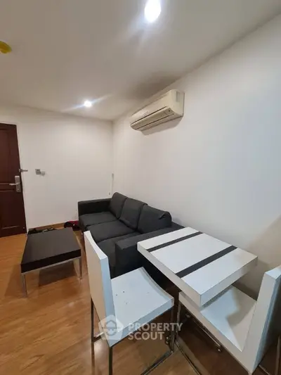 Modern living room with sleek furniture and air conditioning in a cozy apartment.