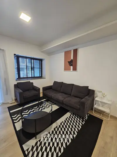 Modern living room with stylish furniture and geometric rug