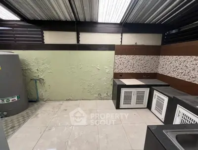 Spacious utility room with tiled flooring and storage units, ideal for laundry or pet care.