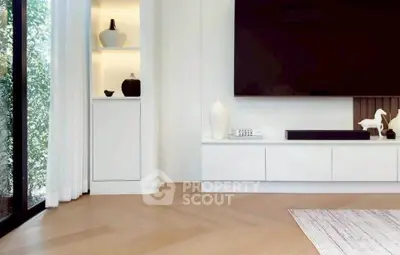 Modern living room with sleek design, large TV, and elegant decor in a bright, airy space.
