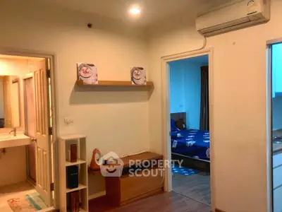 Cozy apartment interior with bedroom and bathroom access, featuring modern air conditioning.