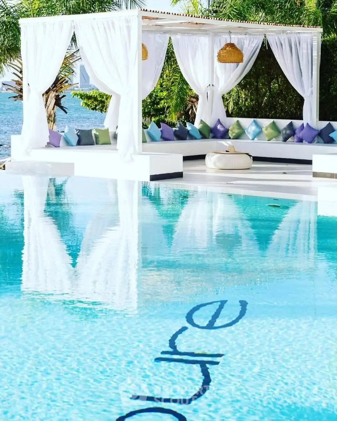 Luxurious poolside cabana with ocean view and elegant decor