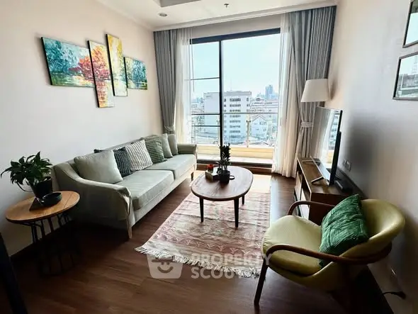 Charming living room with city view, cozy seating, and stylish decor in a modern apartment.