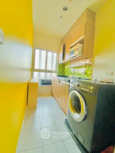 Bright kitchen with yellow walls, modern appliances, and ample natural light.