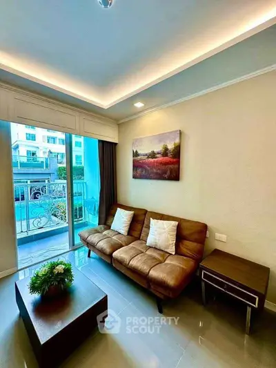 Stylish living room with modern sofa and balcony view in a contemporary apartment.