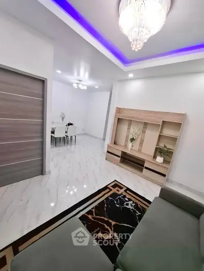 Modern living room with elegant chandelier and stylish furniture