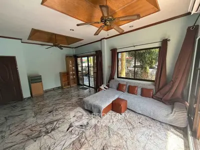 Spacious living room with marble flooring and modern ceiling fans